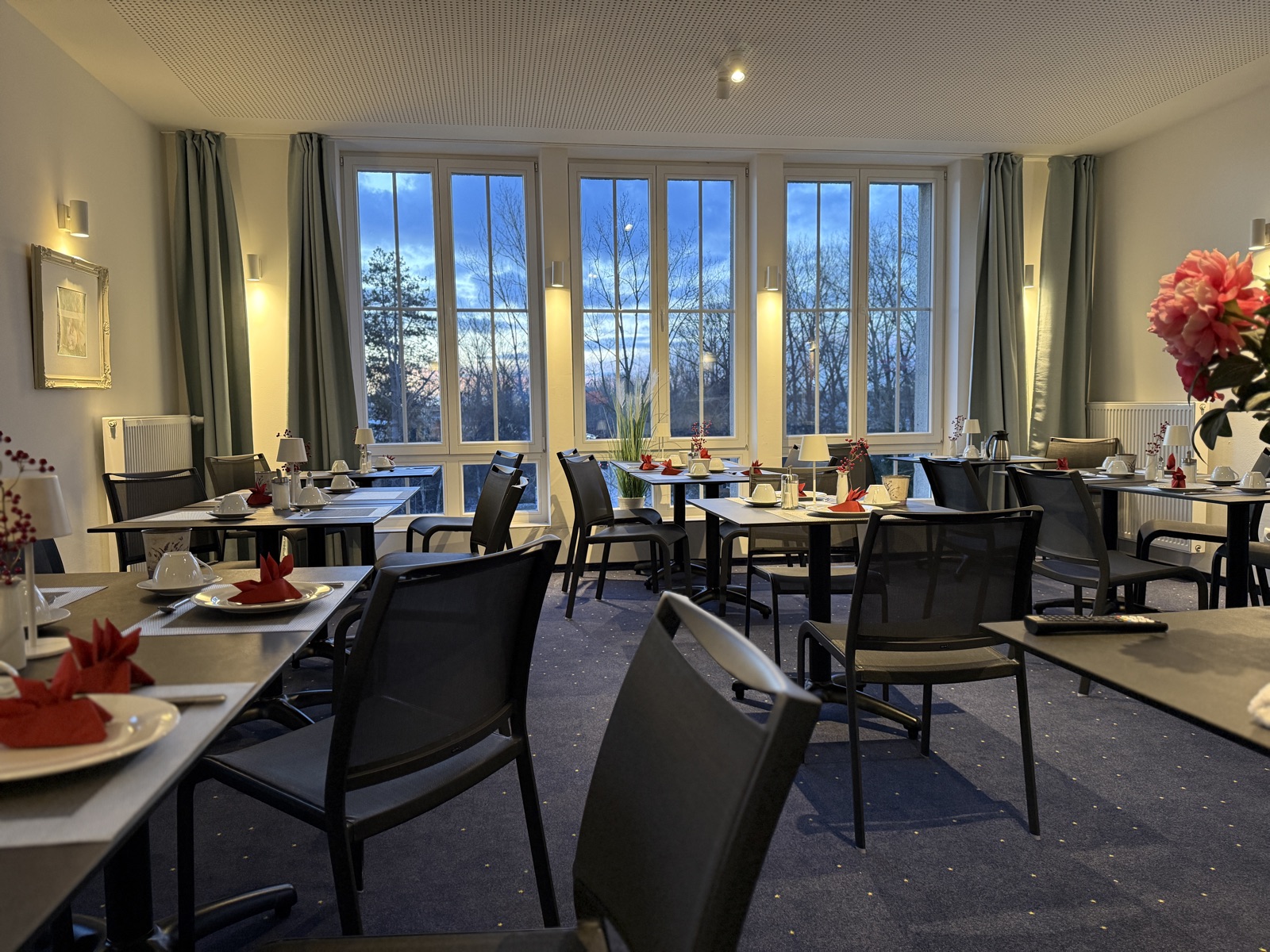 Breakfast room with set tables and large windows